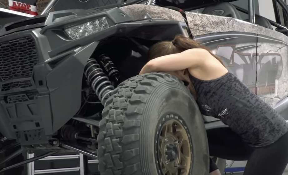 Woman maintaining a Polaris RZR